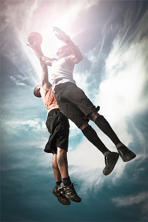 Two Basketball players playing street basket and jumping together to catch the ball Stock Photo - Budget Royalty-Free & Subscription, Code: 400-07899602