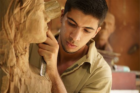 simsearch:400-07899762,k - Man, people, job, young student at work learning craftsman profession in art class, working with wooden statue and carving wood Stock Photo - Budget Royalty-Free & Subscription, Code: 400-07899761