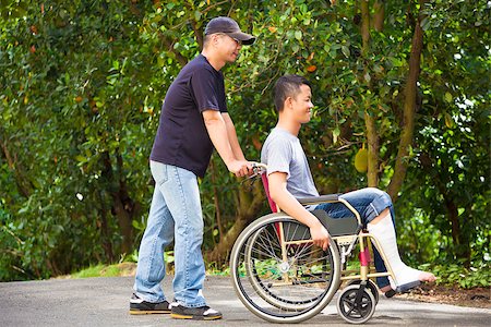 senior laughing with caregiver - young man sitting on a wheelchair with his brother Stock Photo - Budget Royalty-Free & Subscription, Code: 400-07891821