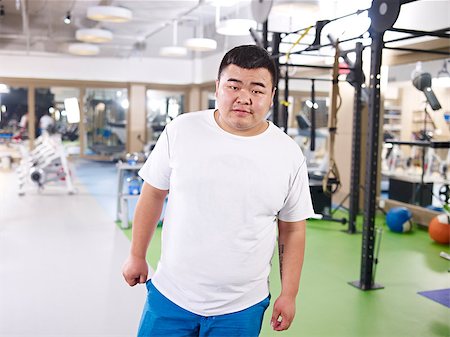 fat man exercising - overweight asian young man in gym ready to exercise. Stock Photo - Budget Royalty-Free & Subscription, Code: 400-07892658