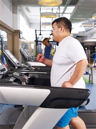 fat man exercising - an overweight young man running on treadmill in fitness center. Stock Photo - Budget Royalty-Free & Subscription, Code: 400-07892680