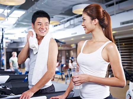 fitness asian couple - young man and woman talking during a break in gym. Stock Photo - Budget Royalty-Free & Subscription, Code: 400-07892682