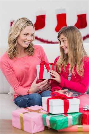 Festive mother and daughter with many gifts at home in the living room Stock Photo - Budget Royalty-Free & Subscription, Code: 400-07902329