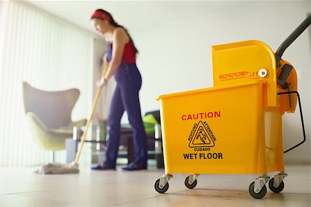 simsearch:400-07902993,k - Young hispanic woman at home, doing chores and housekeeping, wiping floor with water in living room Photographie de stock - Aubaine LD & Abonnement, Code: 400-07903312