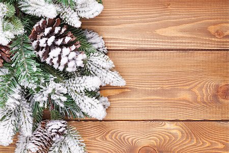 Christmas fir tree with snow on rustic wooden board with copy space Stock Photo - Budget Royalty-Free & Subscription, Code: 400-07917333