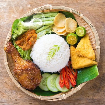 simsearch:400-07418409,k - Famous traditional Indonesian food. Delicious nasi ayam penyet with sambal belacan. Fresh hot with steam smoke. Stock Photo - Budget Royalty-Free & Subscription, Code: 400-07917687