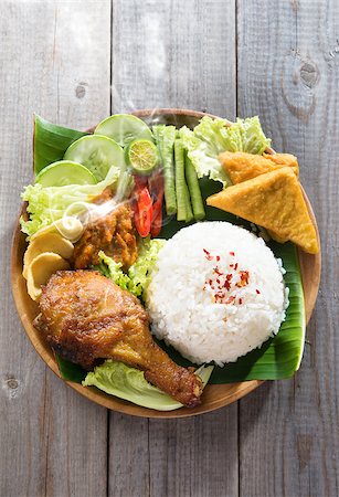 simsearch:400-07418409,k - Popular Indonesian local food nasi ayam penyet, indonesian fried chicken rice with sambal belacan. Fresh hot with steam smoke. Stock Photo - Budget Royalty-Free & Subscription, Code: 400-07917688