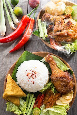 simsearch:400-07418409,k - Popular delicious Indonesian local food nasi ayam penyet, indonesian fried chicken rice with sambal belacan. Fresh hot with steam smoke. Stock Photo - Budget Royalty-Free & Subscription, Code: 400-07917689