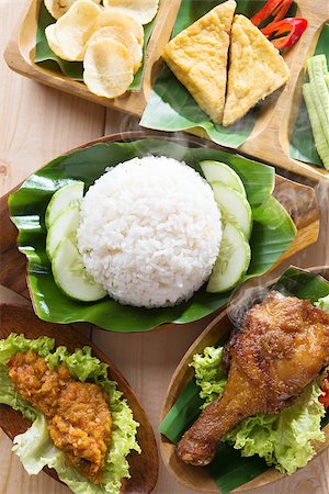simsearch:400-07418409,k - Famous traditional Indonesian food. Delicious nasi ayam penyet with sambal belacan. Fried chicken rice and tea with overhead view. Stock Photo - Budget Royalty-Free & Subscription, Code: 400-07917694