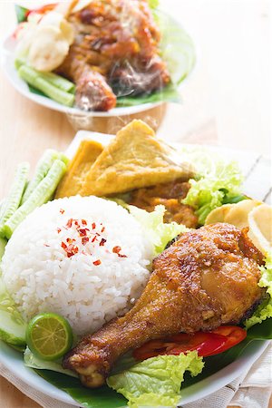 simsearch:400-07418409,k - Famous traditional Malay food. Delicious nasi ayam penyet with sambal belacan. Local flavor. Fresh hot with steam smoke. Stock Photo - Budget Royalty-Free & Subscription, Code: 400-07917690