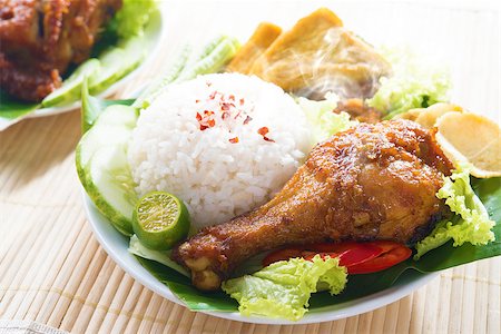simsearch:400-07418409,k - Popular Indonesian local food nasi ayam penyet, indonesian fried chicken rice with sambal belacan. Fresh hot with steam smoke. Stock Photo - Budget Royalty-Free & Subscription, Code: 400-07917691