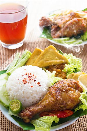 simsearch:400-07418409,k - Popular Indonesian local food nasi ayam penyet, indonesian fried chicken rice. Fresh hot with steam smoke. Stock Photo - Budget Royalty-Free & Subscription, Code: 400-07917692