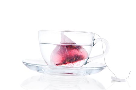 simsearch:400-04273561,k - Luxurious tea still life. Tea bag dissolving in transparent tea cup isolated on white background. Healthy drinking Stock Photo - Budget Royalty-Free & Subscription, Code: 400-07919244