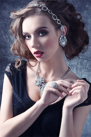 Young, luxurious, romantic girl with curly hairstyle wearing silver, shiny jewellery. She has got gold and purple makeup with red lips. Stock Photo - Budget Royalty-Free & Subscription, Code: 400-07919586