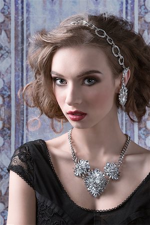 Young, luxurious, romantic woman with curly hairstyle wearing silver, shiny jewellery. She is looking at camera. Stock Photo - Budget Royalty-Free & Subscription, Code: 400-07919588