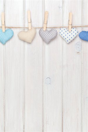 simsearch:400-07919385,k - Valentines day toy hearts hanging on rope over white wooden background with copy space Stock Photo - Budget Royalty-Free & Subscription, Code: 400-07925326