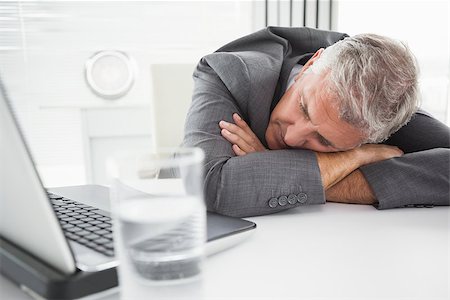 Mature businessman sleeping on desk in his office Stock Photo - Budget Royalty-Free & Subscription, Code: 400-07927903