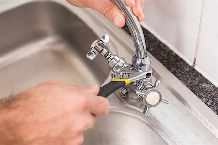 pipe wrench - Plumber fixing the sink with wrench in the kitchen Stock Photo - Budget Royalty-Free & Subscription, Code: 400-07929375