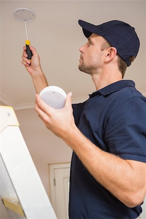 sensor - Handyman installing smoke detector with screwdriver on the ceiling Stock Photo - Budget Royalty-Free & Subscription, Code: 400-07929687