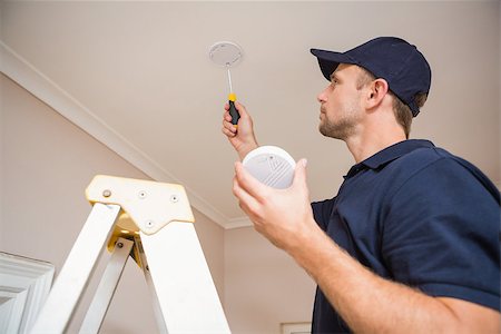 sensor - Handyman installing smoke detector with screwdriver on the ceiling Stock Photo - Budget Royalty-Free & Subscription, Code: 400-07929688