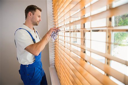 Handyman cleaning blinds with a towel in a new house Stock Photo - Budget Royalty-Free & Subscription, Code: 400-07929787