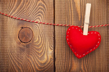 simsearch:400-07919385,k - Red toy valentines heart on rope over wooden background with copy space Stock Photo - Budget Royalty-Free & Subscription, Code: 400-07921415