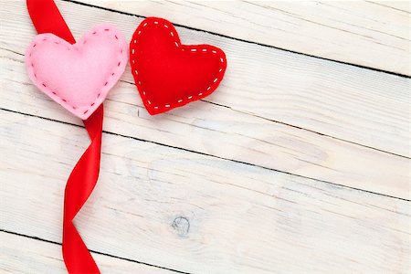 simsearch:400-07919385,k - Valentines day background with toy hearts and ribbon over white wooden table background Stock Photo - Budget Royalty-Free & Subscription, Code: 400-07922855