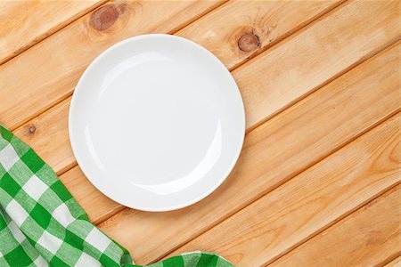 setting kitchen table - Empty plate and towel over wooden table background. View from above with copy space Stock Photo - Budget Royalty-Free & Subscription, Code: 400-07922870