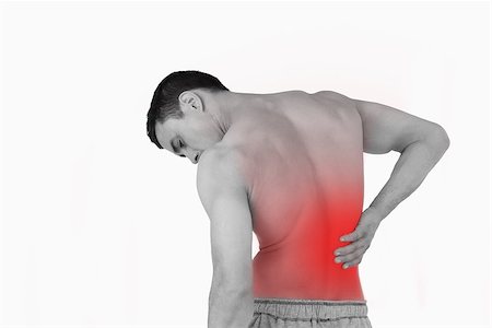 Back view of man suffering from back pain against a white background Stock Photo - Budget Royalty-Free & Subscription, Code: 400-07934206