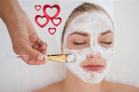 Beautiful blonde getting a facial treatment against pink hearts Stock Photo - Budget Royalty-Free & Subscription, Code: 400-07934400