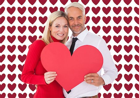 simsearch:400-07957420,k - Handsome man getting a heart card form wife against valentines day pattern Photographie de stock - Aubaine LD & Abonnement, Code: 400-07935301