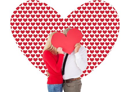 simsearch:400-07957420,k - Handsome man getting a heart card form wife against valentines day pattern Photographie de stock - Aubaine LD & Abonnement, Code: 400-07935302