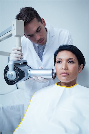 Serious young woman undergoing dental checkup in the dentists chair Stock Photo - Budget Royalty-Free & Subscription, Code: 400-07939267