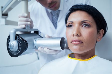 Serious young woman undergoing dental checkup in the dentists chair Stock Photo - Budget Royalty-Free & Subscription, Code: 400-07939268