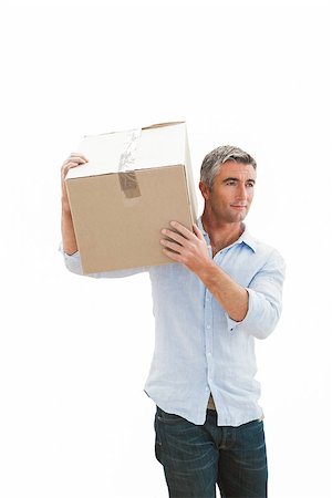 simsearch:400-07930718,k - Smiling man carrying cardboard box on white background Stock Photo - Budget Royalty-Free & Subscription, Code: 400-07930717