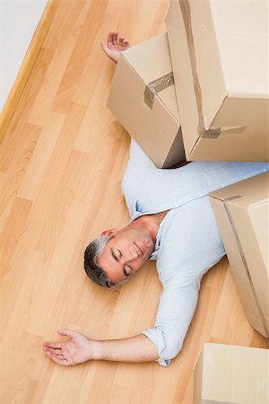 simsearch:400-07930718,k - Man resting under his cardboard boxes at apartment Stock Photo - Budget Royalty-Free & Subscription, Code: 400-07930719