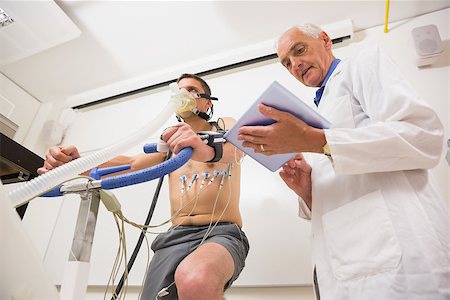 Man doing fitness test on exercise bike at the medical centre Stock Photo - Budget Royalty-Free & Subscription, Code: 400-07940172