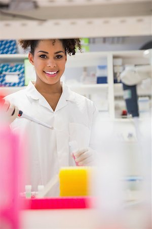 simsearch:649-07118434,k - Pretty science student smiling and holding beaker at the university Stock Photo - Budget Royalty-Free & Subscription, Code: 400-07940283