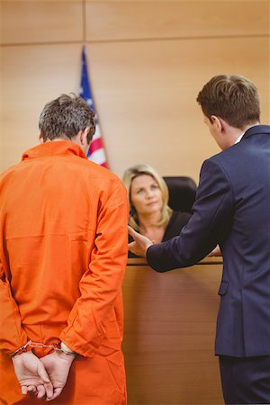 Lawyer and judge speaking next to the criminal in handcuffs in the court room Stock Photo - Budget Royalty-Free & Subscription, Code: 400-07941009