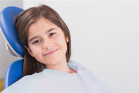 dental bib - Smiling young patient sitting in dentists chair in dental clinic Stock Photo - Budget Royalty-Free & Subscription, Code: 400-07941370