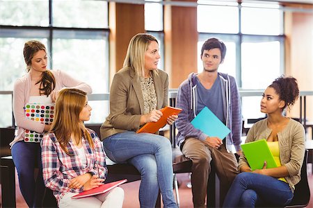Happy students talking with their teacher in the library Stock Photo - Budget Royalty-Free & Subscription, Code: 400-07941758