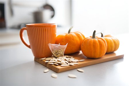 Closeup on small pumpkins seeds and tea bag on table Stock Photo - Budget Royalty-Free & Subscription, Code: 400-07956844