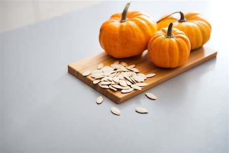 Closeup on small pumpkins and seeds on table Stock Photo - Budget Royalty-Free & Subscription, Code: 400-07956846