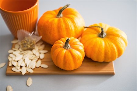 Closeup on small pumpkins and seeds on table Stock Photo - Budget Royalty-Free & Subscription, Code: 400-07956843