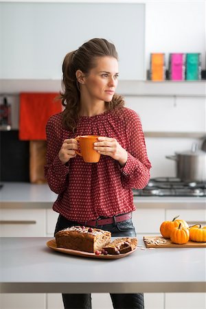 Young housewife drinking tea with freshly baked pumpkin bread with seeds Stock Photo - Budget Royalty-Free & Subscription, Code: 400-07956854
