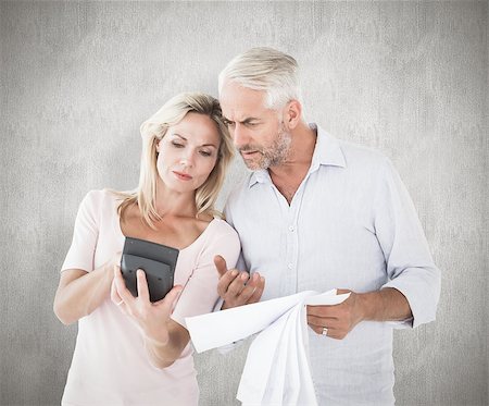 simsearch:400-07957355,k - Anxious couple working out their bills against weathered surface Stock Photo - Budget Royalty-Free & Subscription, Code: 400-07957444