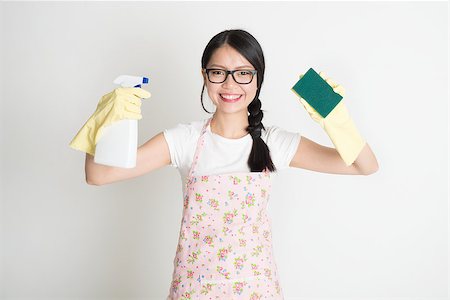 simsearch:400-08693600,k - Asian Chinese young woman housewife, spraying detergent and wiping over dirty glass. Stock Photo - Budget Royalty-Free & Subscription, Code: 400-07974049