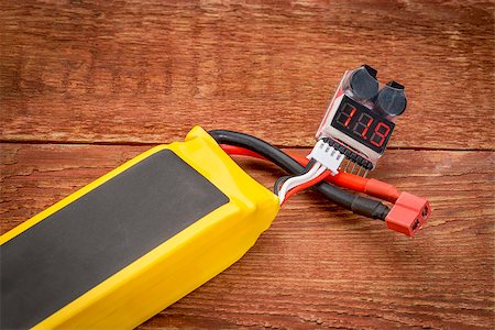 polymer - Lithium-ion polymer rechargeable battery (abbreviated as LiPo, LIP, Li-poly) with a digital LED voltage meter connected to a balance plug. Stock Photo - Budget Royalty-Free & Subscription, Code: 400-07975134