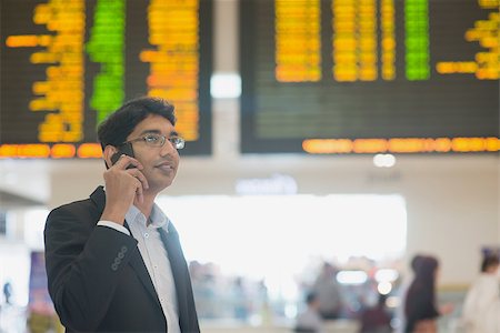 Asian Businessman on the phone during his business travel, at the airport . Stock Photo - Budget Royalty-Free & Subscription, Code: 400-07978333