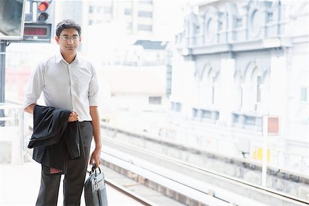 Asian Indian business people waiting train at railway station. Stock Photo - Budget Royalty-Free & Subscription, Code: 400-07978367